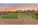Expansive backyard featuring a lush lawn, gazebo, fire pit, and landscaped pathway at 1409 E Dove Pl, Casa Grande, AZ 85122