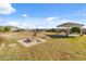 Spacious backyard featuring a fire pit, a covered seating area and trampoline at 1409 E Dove Pl, Casa Grande, AZ 85122