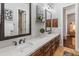 Elegant bathroom featuring double sinks with quartz countertops, dark wood cabinets, and modern decor at 1409 E Dove Pl, Casa Grande, AZ 85122