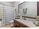 Well-lit bathroom features a spacious vanity, modern fixtures, and a shower/tub combo with stylish curtain at 1409 E Dove Pl, Casa Grande, AZ 85122