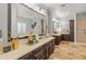 Spacious bathroom with double sink vanity, large mirrors, and separate walk-in shower at 1409 E Dove Pl, Casa Grande, AZ 85122