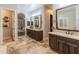 Bathroom with dual sinks, beautiful cabinetry, large mirrors, and lots of counter space at 1409 E Dove Pl, Casa Grande, AZ 85122