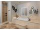 A luxurious bathroom featuring a soaking tub and a separate tiled shower at 1409 E Dove Pl, Casa Grande, AZ 85122