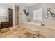 Bright bathroom with double vanities, a soaking tub, and a separate shower at 1409 E Dove Pl, Casa Grande, AZ 85122