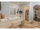 Elegant bathroom featuring a jacuzzi tub, TV and lots of natural light at 1409 E Dove Pl, Casa Grande, AZ 85122
