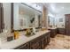 Elegant bathroom featuring dual sinks, large mirror and beautiful cabinets at 1409 E Dove Pl, Casa Grande, AZ 85122