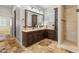 Spacious bathroom with double vanity, large mirror, and a tiled walk-in shower at 1409 E Dove Pl, Casa Grande, AZ 85122