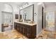 Beautiful bathroom featuring dual sinks, stone tile flooring, walk-in closet, and natural light at 1409 E Dove Pl, Casa Grande, AZ 85122