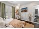 Bright bedroom features a swing chair, hardwood floors, and view to the bath, blending comfort and style at 1409 E Dove Pl, Casa Grande, AZ 85122