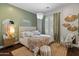 Inviting bedroom with a swing chair, decorative mirror, and natural accents, creating a peaceful escape at 1409 E Dove Pl, Casa Grande, AZ 85122