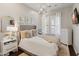 Stylish bedroom features a modern light fixture, neutral tones, and a comfortable bed, creating a serene atmosphere at 1409 E Dove Pl, Casa Grande, AZ 85122