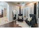 Charming bedroom with hardwood floors, sitting area, natural light and an ensuite bathroom at 1409 E Dove Pl, Casa Grande, AZ 85122
