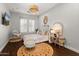 Charming bedroom with a jute rug, hanging chair, and natural lighting at 1409 E Dove Pl, Casa Grande, AZ 85122