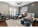 Charming bedroom with two twin beds, blue accents, a ceiling fan, and hardwood floors at 1409 E Dove Pl, Casa Grande, AZ 85122