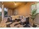 Charming covered patio features plush sectional seating, ceiling fan, and verdant planters perfect for outdoor living at 1409 E Dove Pl, Casa Grande, AZ 85122