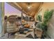 Comfortable covered patio with stylish seating and decorative pillows for relaxation and socializing at 1409 E Dove Pl, Casa Grande, AZ 85122
