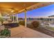 Relaxing covered patio with comfortable seating, outdoor dining area, and views of the landscaped backyard with private pool at 1409 E Dove Pl, Casa Grande, AZ 85122