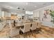 Dining room with travertine flooring, seating for eight and an elegant chandelier; the perfect space for hosting friends at 1409 E Dove Pl, Casa Grande, AZ 85122