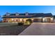 Beautiful two-story home with well-maintained landscaping, dark roof, and a three-car garage at 1409 E Dove Pl, Casa Grande, AZ 85122