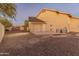 Rear of the house with a three car garage and a large backyard at 1409 E Dove Pl, Casa Grande, AZ 85122
