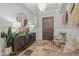 Grand foyer features travertine floors, chandelier, elegant decor, and a rustic wood door at 1409 E Dove Pl, Casa Grande, AZ 85122