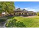 Charming home with large lawn, welcoming porch, and attached three-car garage at 1409 E Dove Pl, Casa Grande, AZ 85122