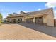 Home with spacious 3-car garage, brick driveway, and lovely landscaping at 1409 E Dove Pl, Casa Grande, AZ 85122