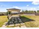 Backyard gazebo with porch swings over looking large yard with basketball court at 1409 E Dove Pl, Casa Grande, AZ 85122