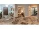 Inviting hallway leads to a luxurious bedroom, showcasing arched doorways and high-end finishes at 1409 E Dove Pl, Casa Grande, AZ 85122