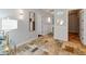Bright hallway featuring travertine floors, wainscoting, and stylish lighting at 1409 E Dove Pl, Casa Grande, AZ 85122