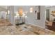 Bright hallway featuring travertine floors, wainscoting, and stylish lighting fixtures at 1409 E Dove Pl, Casa Grande, AZ 85122