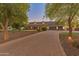 Beautiful home with three-car garage and tree-lined driveway at 1409 E Dove Pl, Casa Grande, AZ 85122