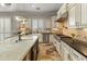 Well-equipped kitchen featuring granite countertops, travertine flooring, stainless appliances, and a large island with sink at 1409 E Dove Pl, Casa Grande, AZ 85122