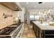 Kitchen featuring stainless steel appliances, travertine flooring, a kitchen island with a sink, and a tile backsplash at 1409 E Dove Pl, Casa Grande, AZ 85122
