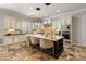 Kitchen island with granite countertops, stainless appliances, seating for three and pendant lighting at 1409 E Dove Pl, Casa Grande, AZ 85122