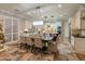 Kitchen and dining area showcases custom cabinets, stainless steel appliances, granite countertops, and stylish lighting fixtures at 1409 E Dove Pl, Casa Grande, AZ 85122
