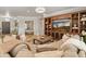 Comfortable living room featuring a large built-in entertainment center, plush sofa, and an open doorway to the main bedroom at 1409 E Dove Pl, Casa Grande, AZ 85122