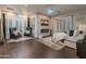 Spacious main bedroom featuring hardwood floors, a cozy seating area, fireplace, and stylish décor at 1409 E Dove Pl, Casa Grande, AZ 85122