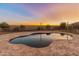 Inviting in-ground pool surrounded by beautiful desert landscaping and a brick paver patio for outdoor enjoyment at 1409 E Dove Pl, Casa Grande, AZ 85122
