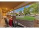 Inviting front porch with rocking chairs, brick columns, and views of the landscaped yard at 1409 E Dove Pl, Casa Grande, AZ 85122