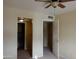 A view of the bedroom featuring neutral walls, carpet, ceiling fan, and access to the bathroom at 151 E Broadway Rd # 210, Tempe, AZ 85282
