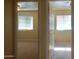 An open doorway shows two bedrooms with neutral walls, carpeted floors, and horizontal blinds at 151 E Broadway Rd # 210, Tempe, AZ 85282