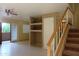 Bright living room featuring tile floors, a ceiling fan, sliding glass doors to the outside, and staircase at 151 E Broadway Rd # 210, Tempe, AZ 85282