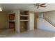 Spacious living room with ceiling fan, staircase, tile flooring and access to the kitchen at 151 E Broadway Rd # 210, Tempe, AZ 85282