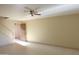 Spacious living room with neutral paint, tile floors, and ceiling fan at 151 E Broadway Rd # 210, Tempe, AZ 85282