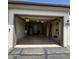An empty, attached garage with storage space and overhead lighting at 17205 N 107Th Ave, Sun City, AZ 85373