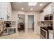 Well-lit kitchen with stainless steel appliances, granite countertops, and a pass-through window to the dining area at 17205 N 107Th Ave, Sun City, AZ 85373