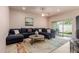 Relaxing living room featuring a comfortable sectional sofa and a sliding door to the backyard at 17205 N 107Th Ave, Sun City, AZ 85373