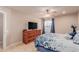 Cozy bedroom featuring a window, a ceiling fan, and a dresser with a TV at 17205 N 107Th Ave, Sun City, AZ 85373