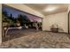 Covered patio area featuring paved flooring, rock landscaping, and a built-in barbecue at 1725 E Everglade Ln, Gilbert, AZ 85298
